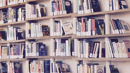 books stacked on a book shelf