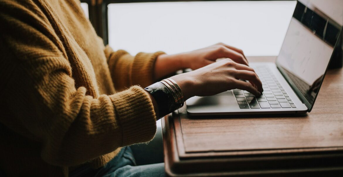 person sitting front of laptop