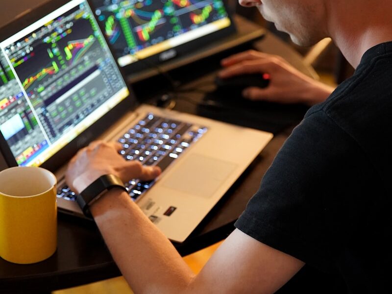 man sitting in front of the laptop