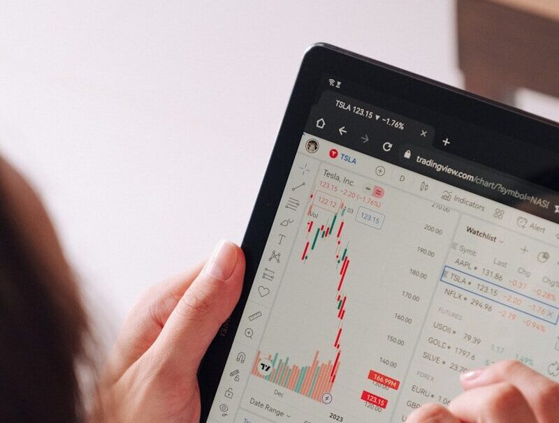 a woman holding a tablet with a chart on it